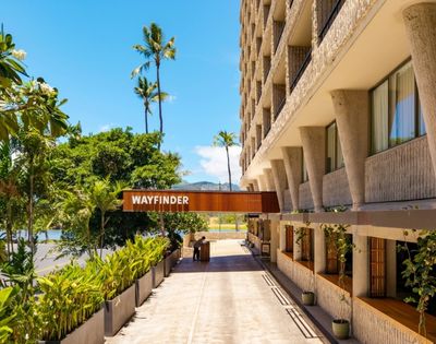 A sunlit hotel entrance with a 