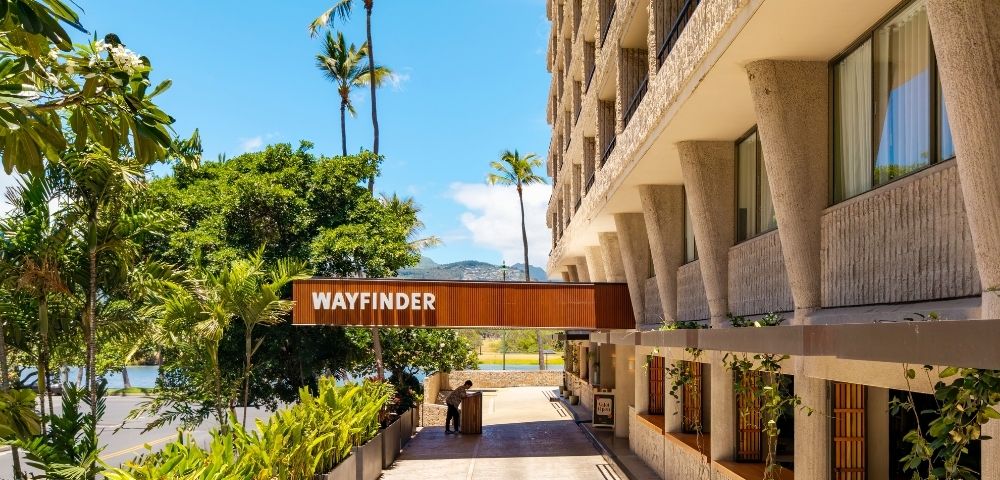 A sunlit hotel entrance with a 