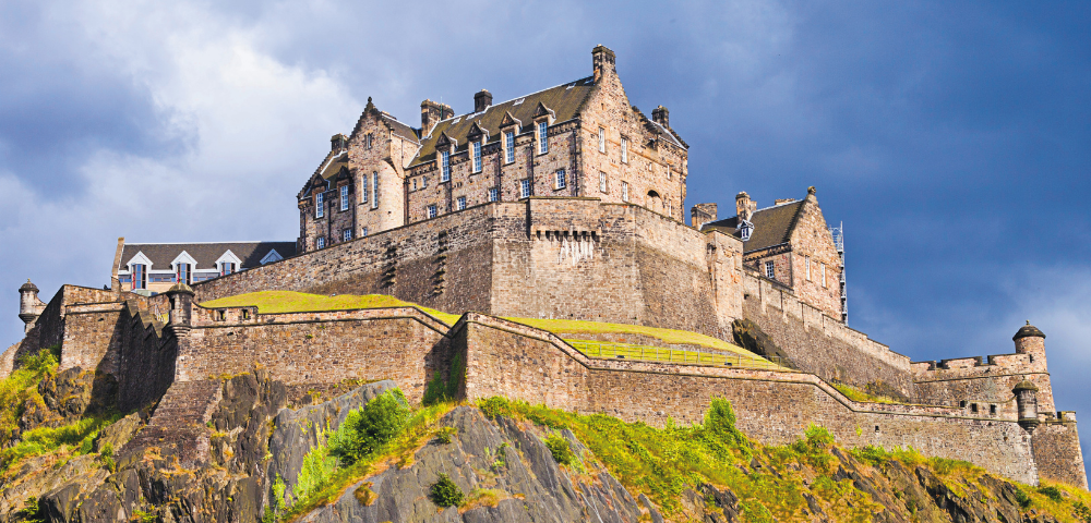 A majestic medieval castle perched on a rocky hill, with stone walls and turrets. Sunlit, under a dramatic, cloudy sky, evoking strength and history.