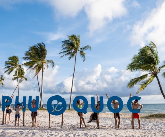 Groups of people interact playfully with large 