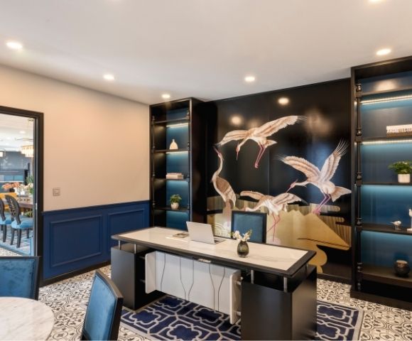 Modern office with a marble desk, ornate tile floor, and a wall mural of flying cranes. Shelves with decor items evoke elegance and tranquility.