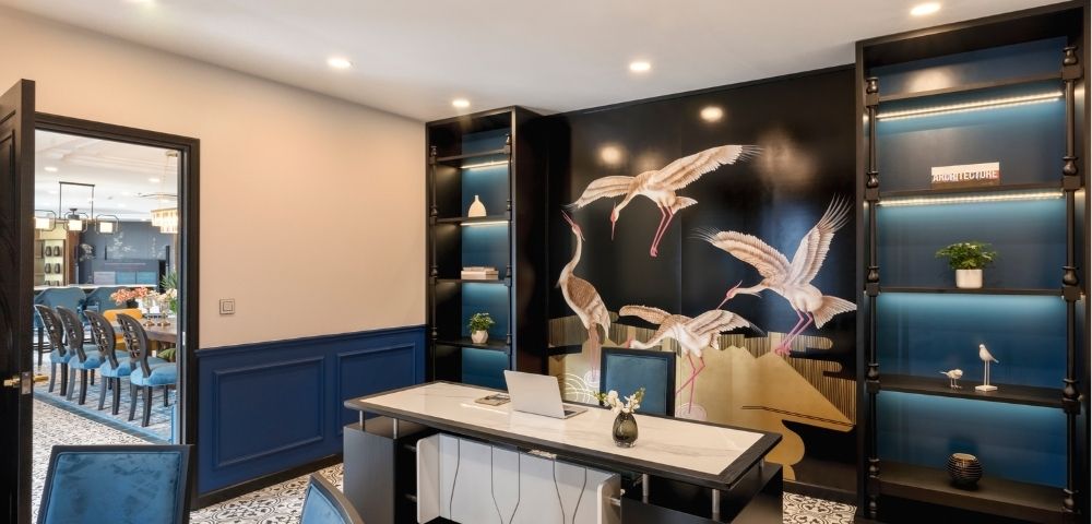 Modern office with a marble desk, ornate tile floor, and a wall mural of flying cranes. Shelves with decor items evoke elegance and tranquility.