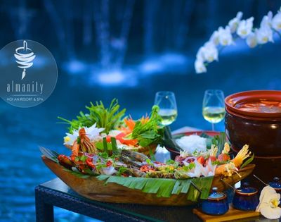 Luxurious seafood platter on a wooden table by a pool, with two wine glasses, vibrant floral decorations, and an elegant, tranquil ambiance.