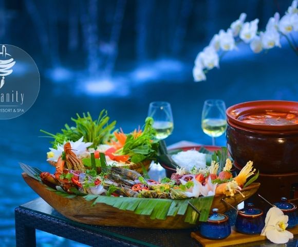 Luxurious seafood platter on a wooden table by a pool, with two wine glasses, vibrant floral decorations, and an elegant, tranquil ambiance.