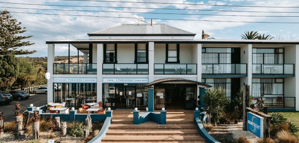 Two-story building with a modern facade and large windows, labeled 