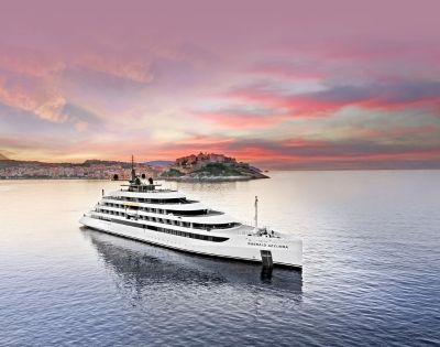 The luxury yacht Emerald Azzurra cruising on tranquil seas at sunset, with a Mediterranean coastal town and pastel sky in the background.