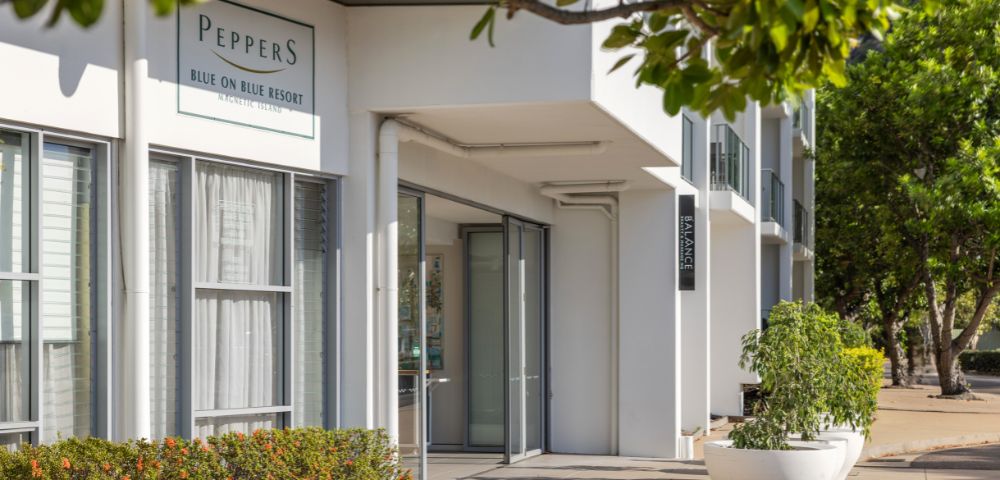 Modern resort entrance labeled 