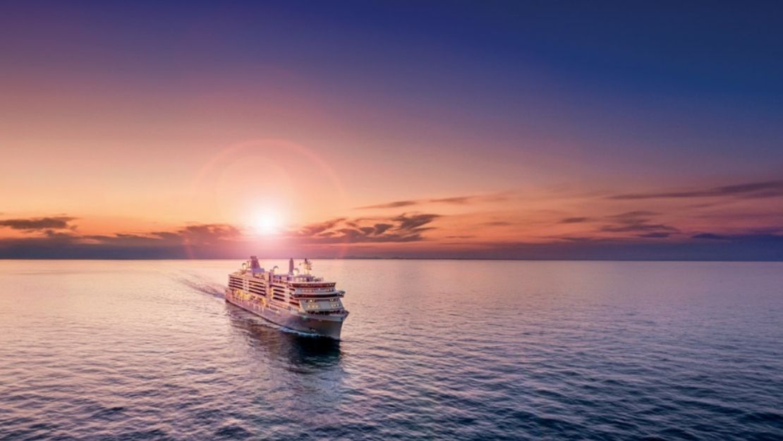 Cruise ship on calm ocean at sunset, with the sun low on the horizon, casting a warm glow across the sky and serene water, evoking relaxation and adventure.