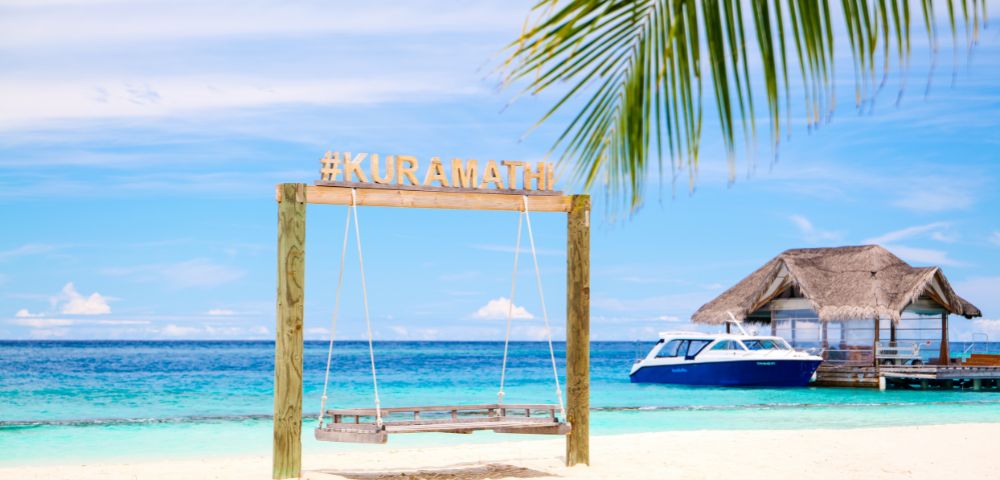 Tropical beach scene with a wooden swing marked 