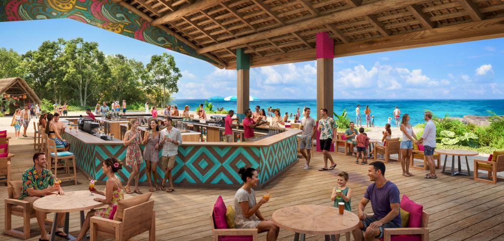 A vibrant beachside bar with people enjoying drinks under a colorful, open wooden roof. Clear blue sky and ocean in the background convey a relaxed, tropical mood.