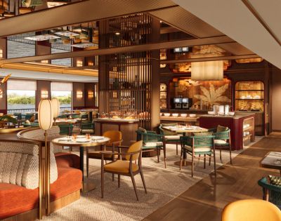 Elegant restaurant interior with warm lighting and modern decor. Features round tables, plush seating, and a stylish mirrored ceiling, creating a cozy, inviting atmosphere.