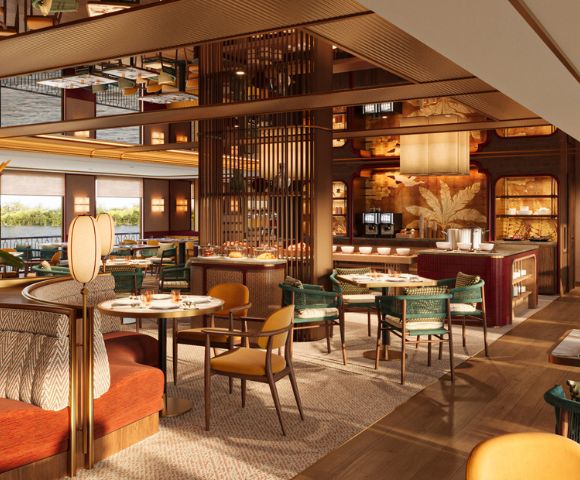 Elegant restaurant interior with warm lighting and modern decor. Features round tables, plush seating, and a stylish mirrored ceiling, creating a cozy, inviting atmosphere.