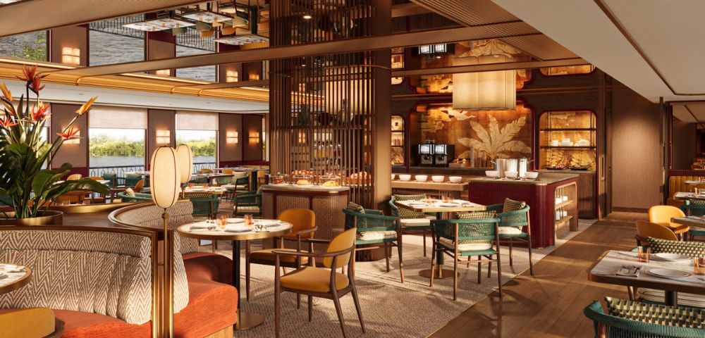 Elegant restaurant interior with warm lighting and modern decor. Features round tables, plush seating, and a stylish mirrored ceiling, creating a cozy, inviting atmosphere.