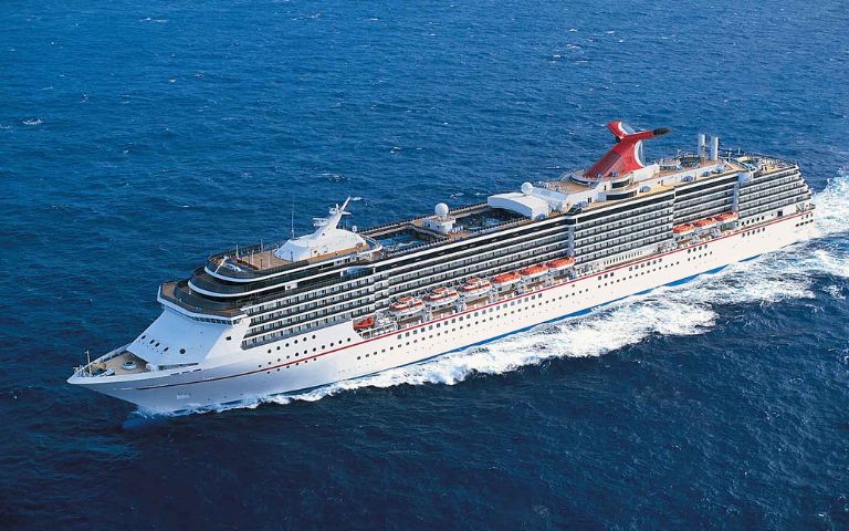 A large white cruise ship sails smoothly on calm blue waters. Multiple decks with lifeboats and a distinctive red funnel are visible, conveying relaxation and adventure.