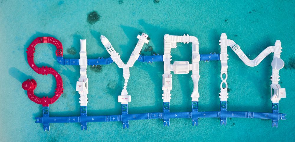 Floating letters on turquoise water spell 