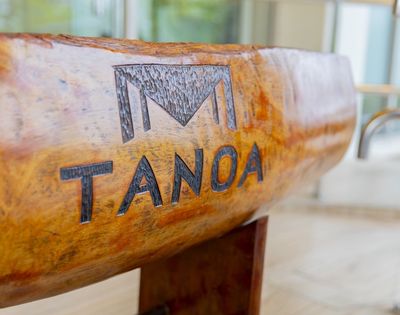 Close-up of a carved wooden bowl with the word 