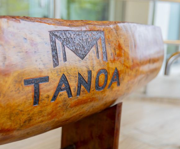 Close-up of a carved wooden bowl with the word 