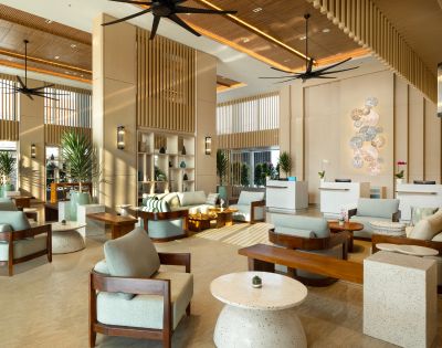 Modern hotel lobby with light wood accents, elegant seating, and soft lighting. The setting conveys a welcoming and serene atmosphere.