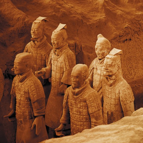 Terracotta Warriors stand in formation, displaying intricate armor and hairstyles. The clay sculptures convey a solemn and historical tone.