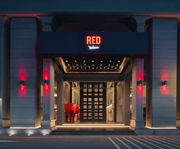 Entrance of a modern building with a sign reading 
