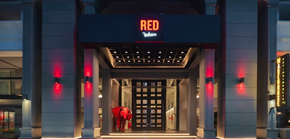 Entrance of a modern building with a sign reading 