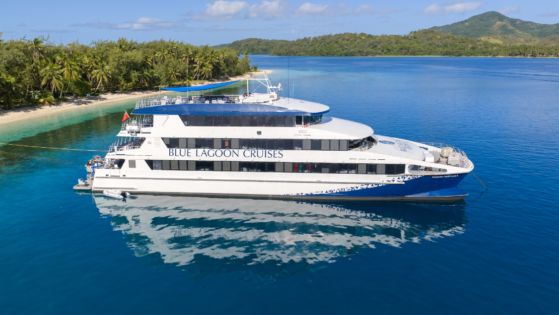 A large white and blue cruise ship labeled 