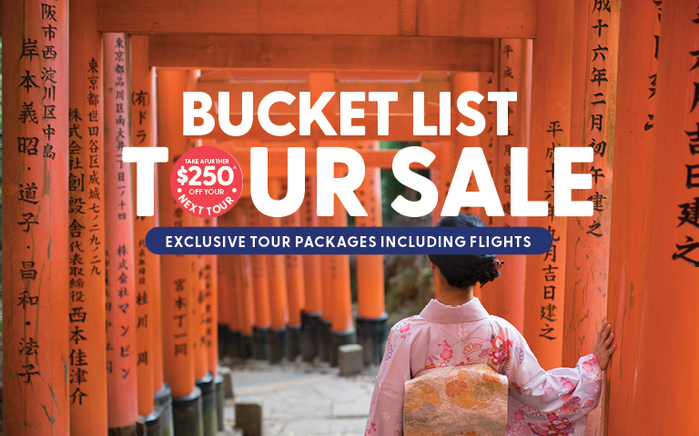 A scenic tropical bay with green islands and turquoise water promoting a bucket list tour sale.