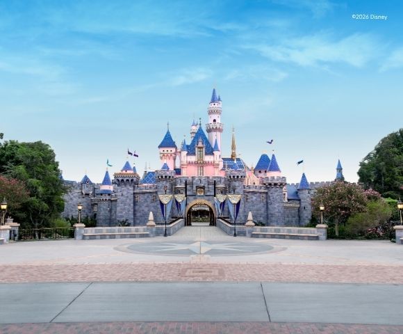 Beautiful stunning day at Disney with the castle, blue skies and fluffy white clouds