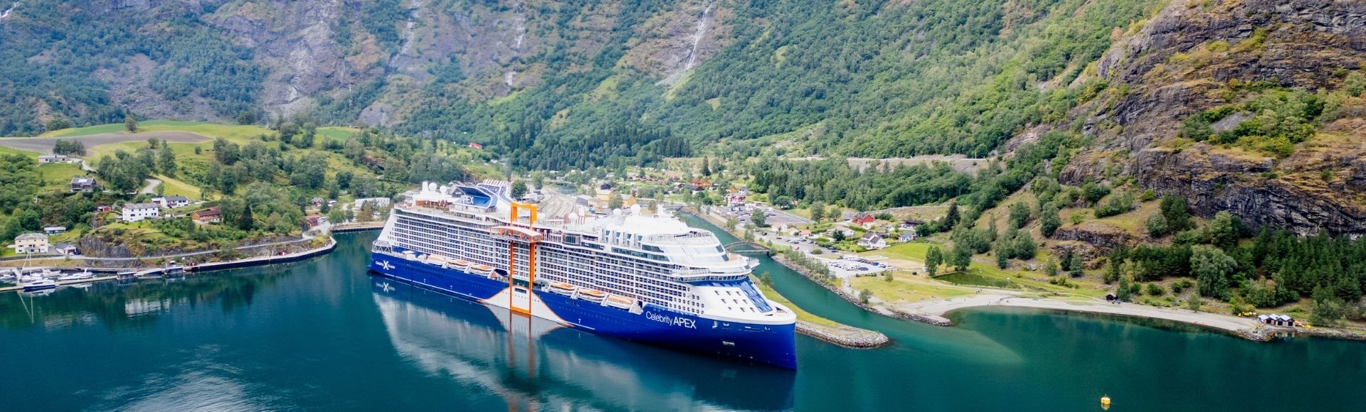 A large, modern cruise ship with blue and white livery, named 