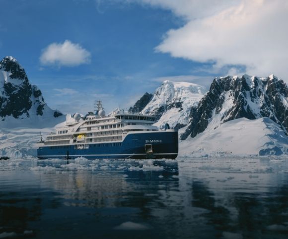 A blue and white expedition cruise ship named 
