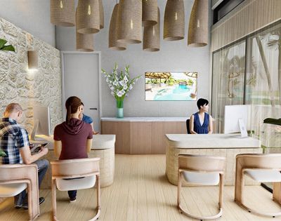 A bright, modern reception area with a light stone wall, pendant lighting, and a large television displaying a pool scene. Multiple reception desks with computers are visible, with staff and clients interacting.