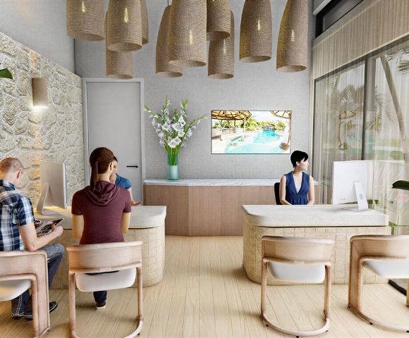 A bright, modern reception area with a light stone wall, pendant lighting, and a large television displaying a pool scene. Multiple reception desks with computers are visible, with staff and clients interacting.