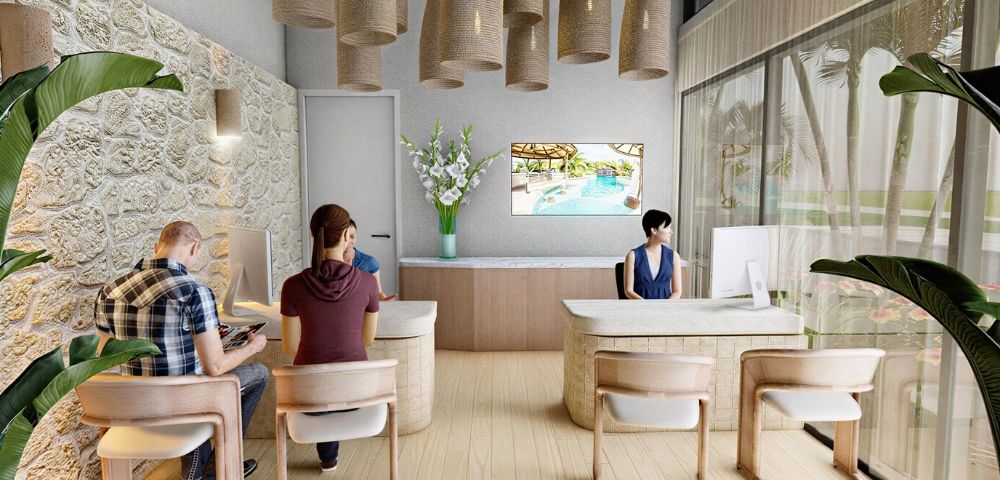A bright, modern reception area with a light stone wall, pendant lighting, and a large television displaying a pool scene. Multiple reception desks with computers are visible, with staff and clients interacting.