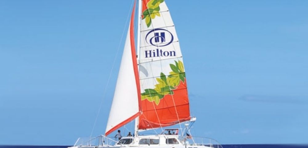 A white catamaran sailboat named 