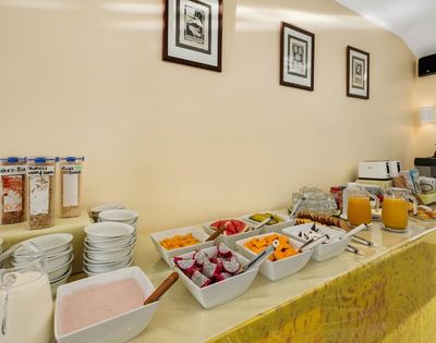 Buffet breakfast station displaying breads, cereals, and beverage options
