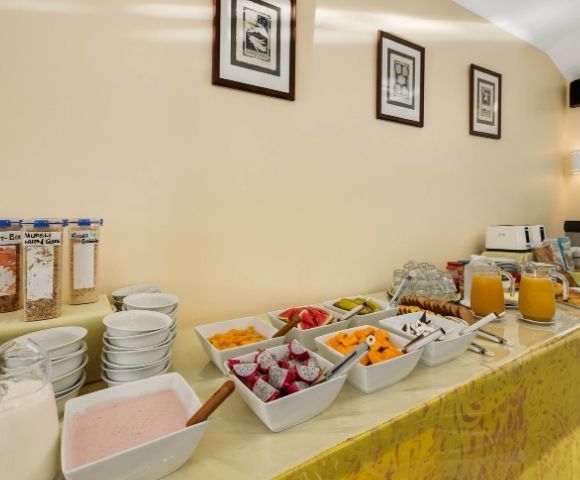 Buffet breakfast station displaying breads, cereals, and beverage options