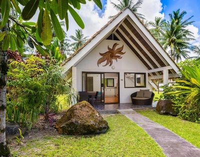 Tropical garden pathway leading to a private bungalow-style accommodation