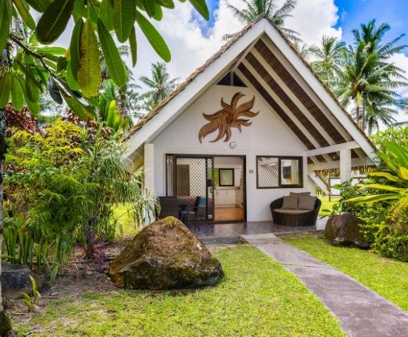 Tropical garden pathway leading to a private bungalow-style accommodation