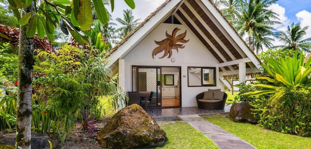 Tropical garden pathway leading to a private bungalow-style accommodation
