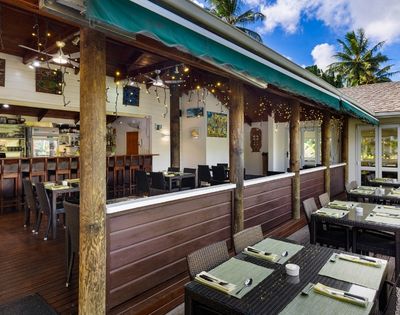 Exterior covered terrace with bar seating and tropical views
