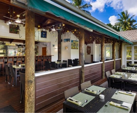 Exterior covered terrace with bar seating and tropical views