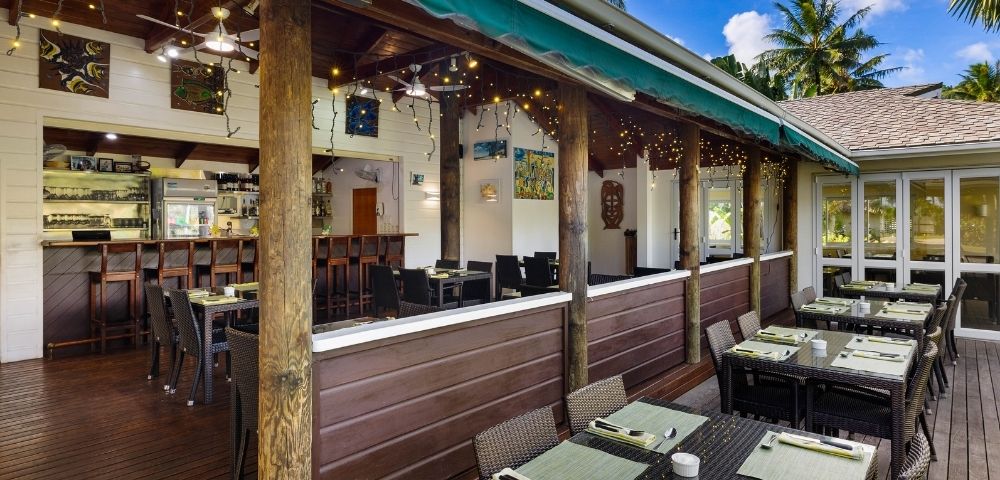 Exterior covered terrace with bar seating and tropical views