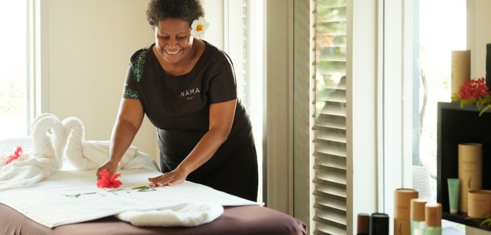 Spa treatment room with massage bed and natural lighting