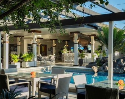 Open-air restaurant terrace overlooking the resort pool