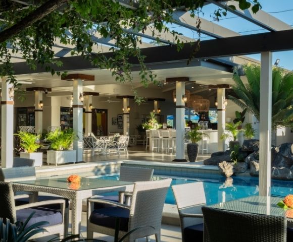 Open-air restaurant terrace overlooking the resort pool