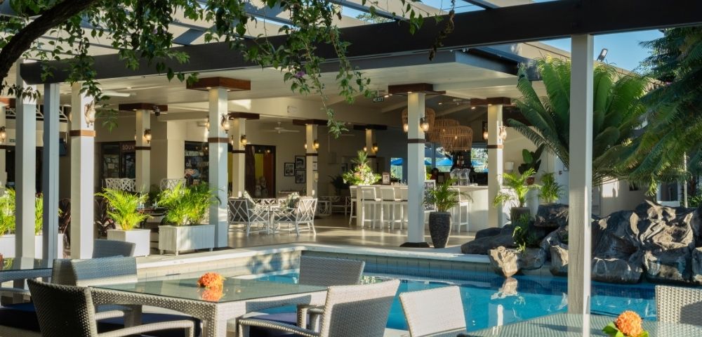 Open-air restaurant terrace overlooking the resort pool