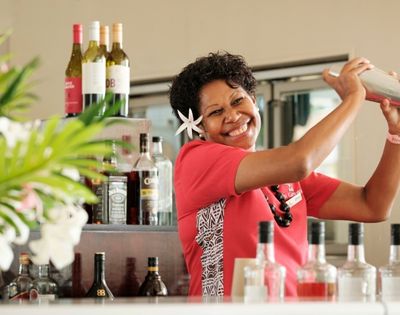Bartender preparing drinks behind the resort bar