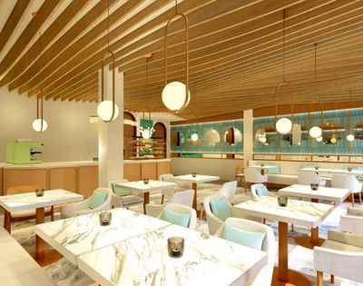 Modern cafe interior with marble tables, light blue and beige chairs, wooden ceiling beams, and round pendant lights.