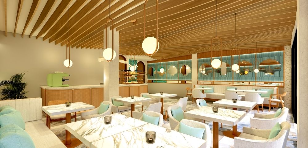 Modern cafe interior with marble tables, light blue and beige chairs, wooden ceiling beams, and round pendant lights.