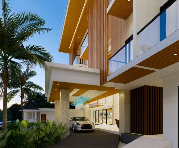 A modern resort entrance with palm trees, a silver car, and a multi-story building with wood and glass accents.